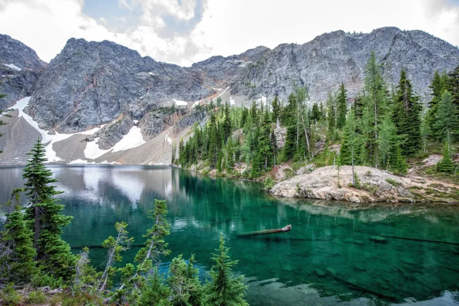 A crystal clear blue lake formed into North Cascades mountains.