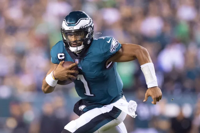 Eagles QB Jalen Hurts powers through Buccaneers defense in intense action shot (Photo by Mitchell Leff/Getty Images)